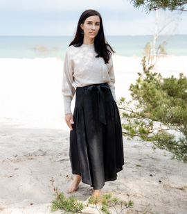 Long pleated linen skirt with a belt and asymmetrical hem