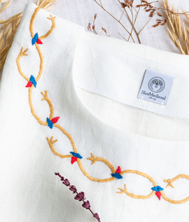 Wide linen dress with hand-embroidered neckline